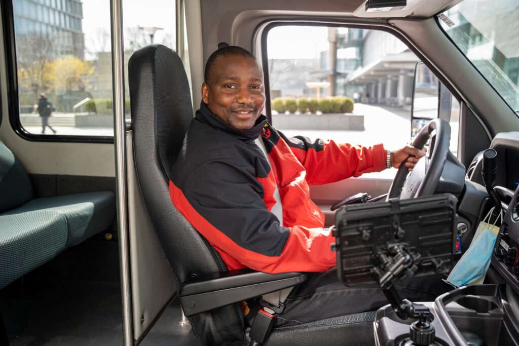 SP+ shuttle bus driver behind the wheel
