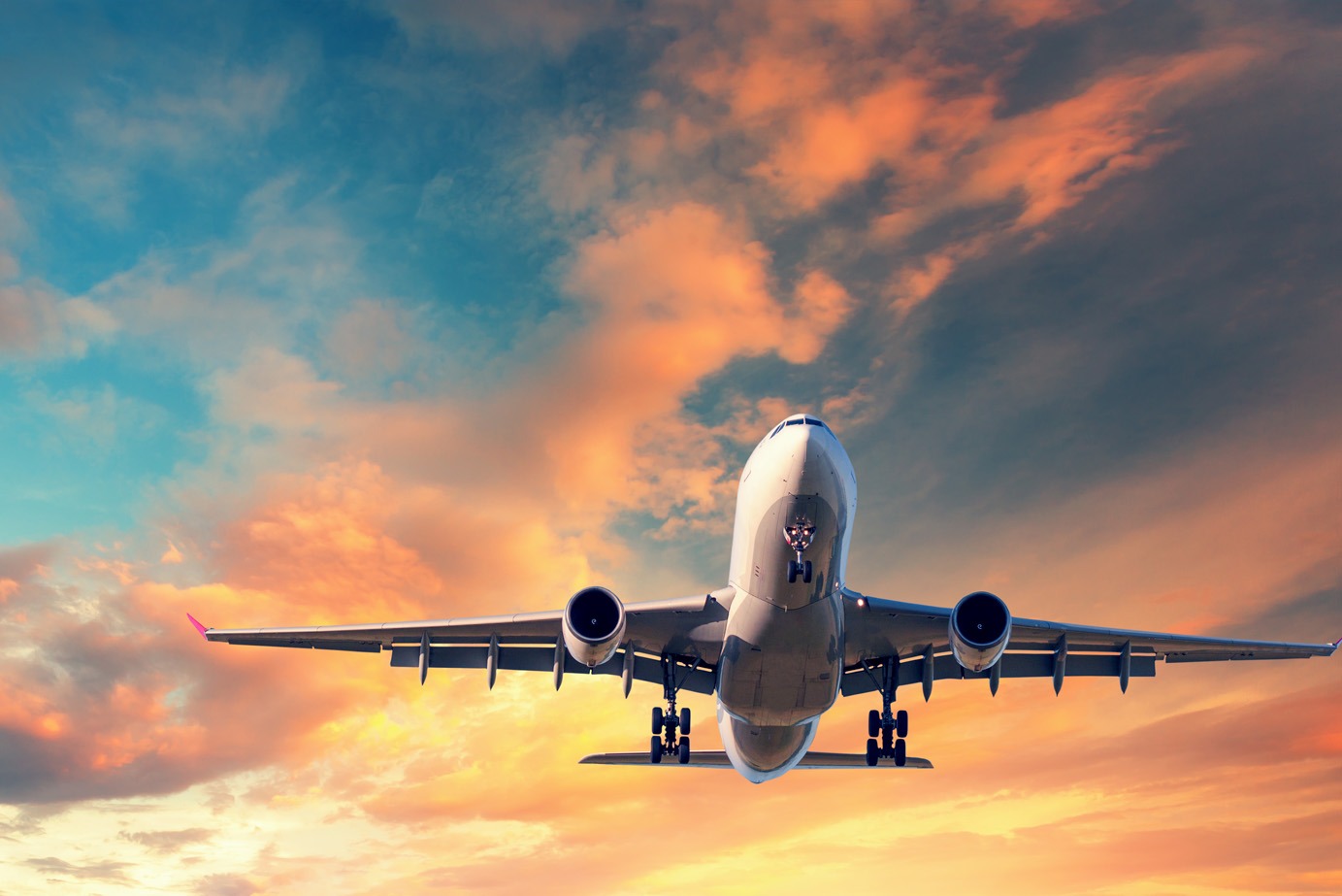 airplane flying at sunset