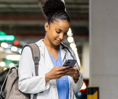 Woman using her phone in a parking garage